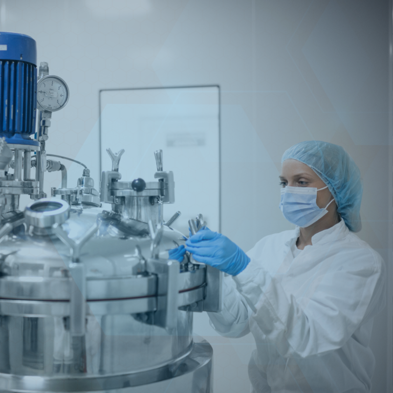A technician inspects chemical vials in a lab.